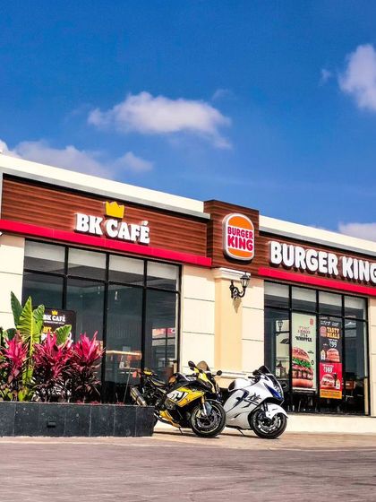A pair of superbikes parked outside Burger King, ready for a royal feast before hitting the road again.