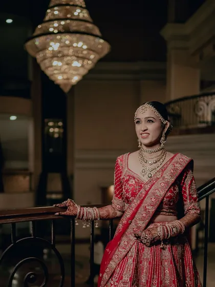 The grandeur of the venue is matched by the grandeur of the bride. Her makeup is elegant and sophisticated, perfect for her royal wedding.