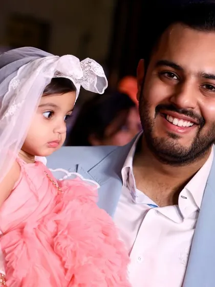 A close-up shot capturing the loving gaze of a father towards his daughter. These intimate portraits are precious keepsakes from any family function.