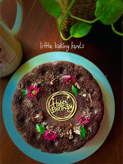 A gluten-free and vegan rich chocolate cake with gulkand (rose jam). It's baked with jowar flour and almond milk, a decadent treat for anyone with dietary restrictions.