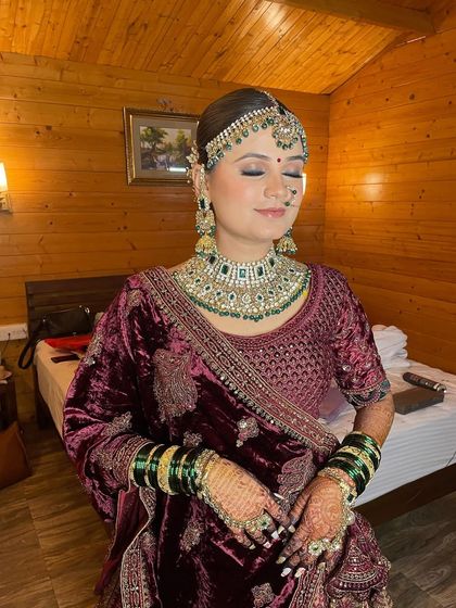Showcasing the royal elegance of this bride's reception look, with soft glam makeup that complements her rich velvet lehenga.