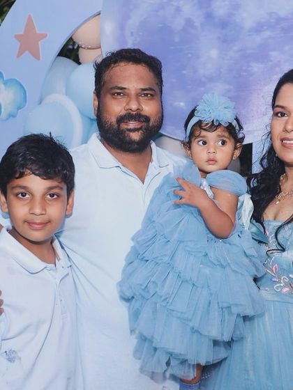 A sweet family photo from Aira's "First Trip Around the Moon" party.