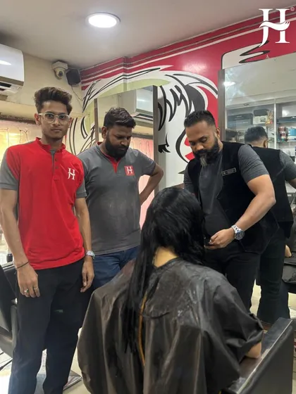 This is my promise of full support in action. Here, one of my senior experts is providing hands-on haircut training to a salon team. We ensure your staff is always learning and updated with the latest techniques.