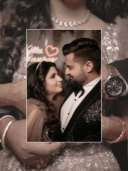 A creative and intimate close-up. The focus is on the couple's loving gaze, framed by their own embrace, with a small heart graphic adding a sweet touch.