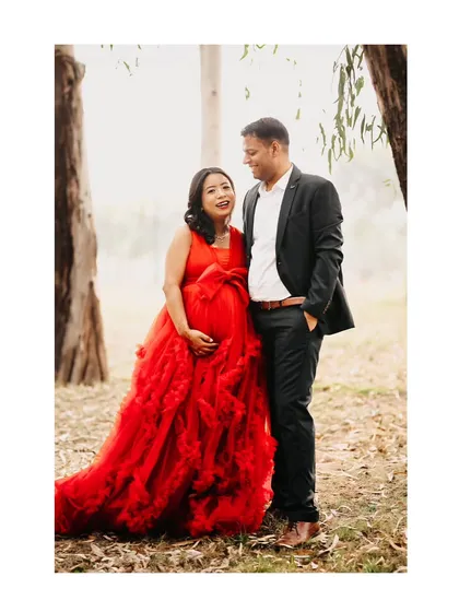 A happy, candid shot of an expecting couple sharing a laugh during their outdoor maternity session. We love capturing these unposed moments that truly reflect a couple's connection.