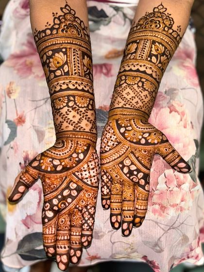 A lovely full-hand design with a mix of floral bands and traditional check patterns, perfect for any festive occasion.