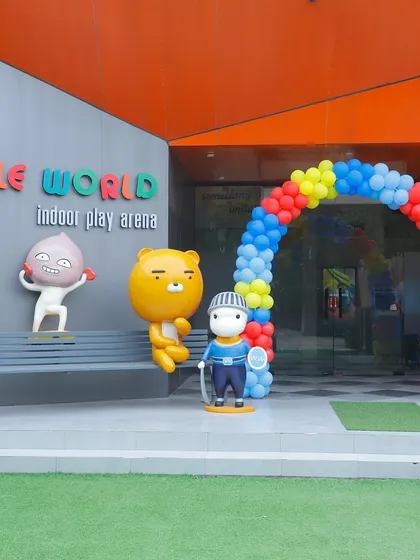 The entrance to Wobble World decorated with a colorful balloon arch for a carnival-themed party, welcoming guests to the fun.
