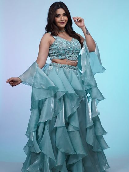 This powder blue lehenga with a tiered, ruffled skirt is pure magic. The sequined blouse adds just the right amount of sparkle for a reception or engagement party.