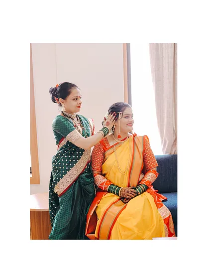 A mother helps her daughter, the bride, get ready. These behind the scenes family moments are just as important as the main ceremony.