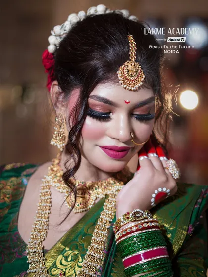 A detailed close-up of the festive makeup. The winged eyeliner, magenta lips, and traditional jewelry are key elements our students learn for creating classic Indian looks.