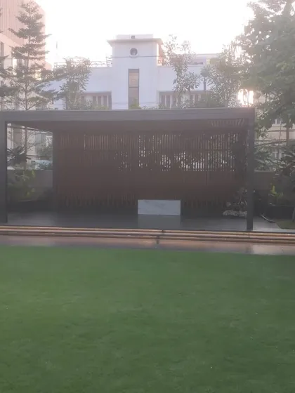 This large pergola and screen structure creates a private and shaded seating area within a larger garden. It's a great way to create distinct zones in your outdoor space.