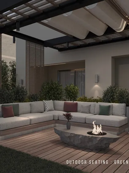 This cozy outdoor seating area features a large L-shaped sofa and a unique stone fire pit table. The retractable pergola roof allows for flexibility, providing shade during the day and an open view of the stars at night.