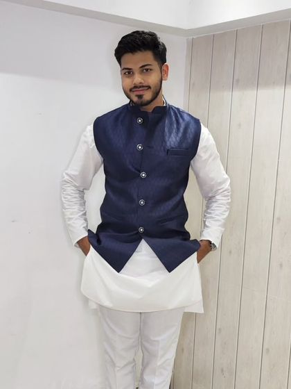 A full-length view of the navy blue jacquard jacket paired with a white kurta, a timeless and elegant combination.