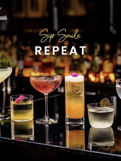 Sip, Smile, Repeat. A lineup of our diverse and beautiful cocktails on a bar top, representing the perfect formula for a happy and memorable event.