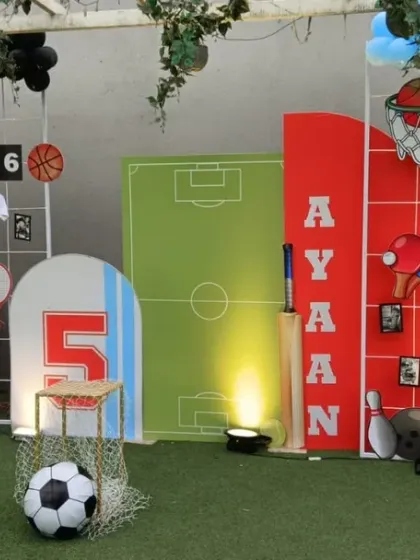 An action-packed sports-themed birthday party, featuring a multi-sport backdrop with silhouettes of players, a mini soccer field, and personalized details for the birthday boy.