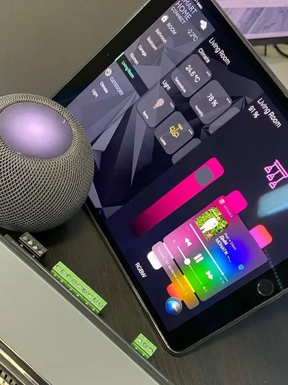 We integrate your entire smart home into a single, intuitive interface. Here you can see a detailed control dashboard on an iPad, managing lighting, climate, and multi-room audio, all working in sync with an Apple HomePod for voice commands.