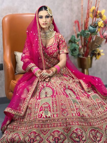 A full-length seated portrait, showcasing the magnificent lehenga and the complete bridal look.
