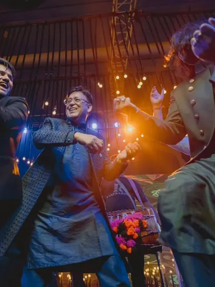 The groomsmen crew bringing the party to life. This candid shot captures the pure joy and energy of a group performance.
