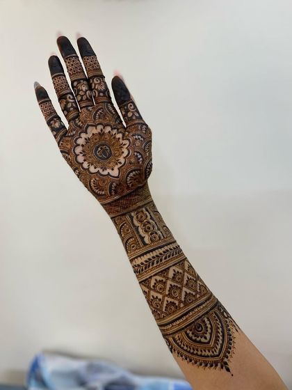 A full-arm design with a prominent mandala on the palm. Trusting in Allah's plan, I pour my heart into creating the best for my brides.