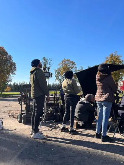 A wide shot of the film crew setting up for a scene on location in Poland. This shows the sheer amount of equipment and teamwork that goes into every single shot.