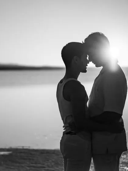 A powerful and intimate silhouette of two souls connecting as the sun sets over the water in Turkey. This image represents our core belief that all love is beautiful and deserves to be celebrated with artistry and grace.