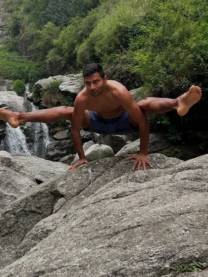 Finding stillness and strength in nature. This is what our practice is about: connecting your body's power with the peace of the outdoors, like holding a challenging firefly pose against the backdrop of a waterfall.