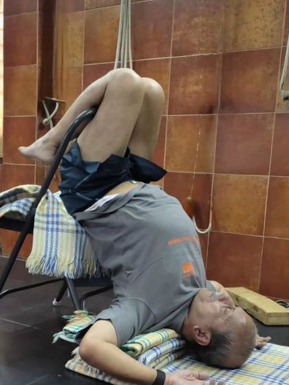 A supported backbend on a chair.