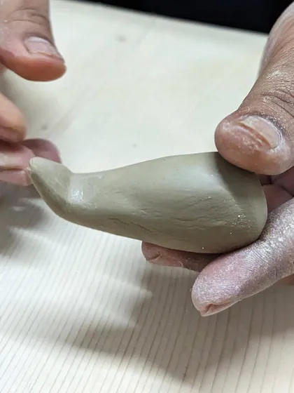 The first step in sculpting the mouse for our Ganesha workshop is shaping the body from a small piece of clay.
