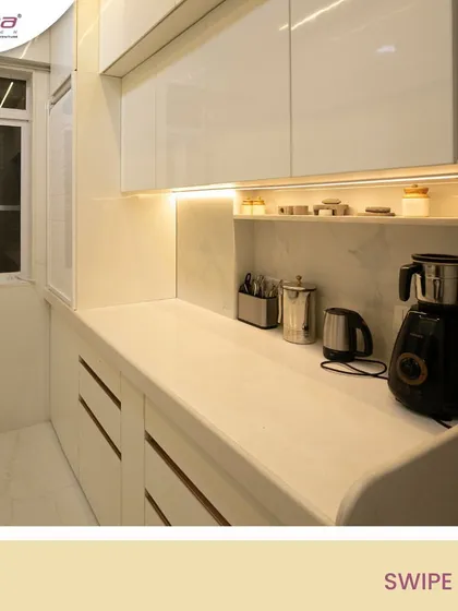 An all-white kitchen is timeless and makes any space feel brighter and more spacious. In this parallel kitchen layout, I used glossy white laminates and warm under-cabinet lighting to create a clean, functional, and elegant cooking area.