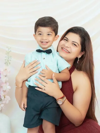 A mother holds her son, both sharing a beautiful smile. These are the simple, happy moments we love to freeze in time.