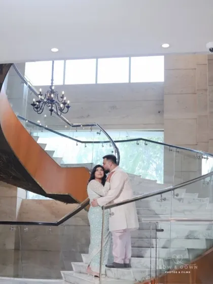A romantic portrait on a grand staircase. This shot from their Roka ceremony uses the architecture to create a beautiful frame for the couple's intimate embrace.