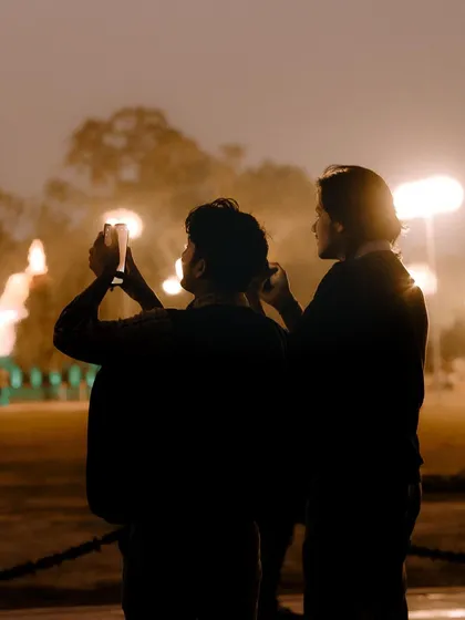 I find it fascinating to photograph other people taking photos. This silhouette shot captures a moment of shared creativity against the evening lights at India Gate.