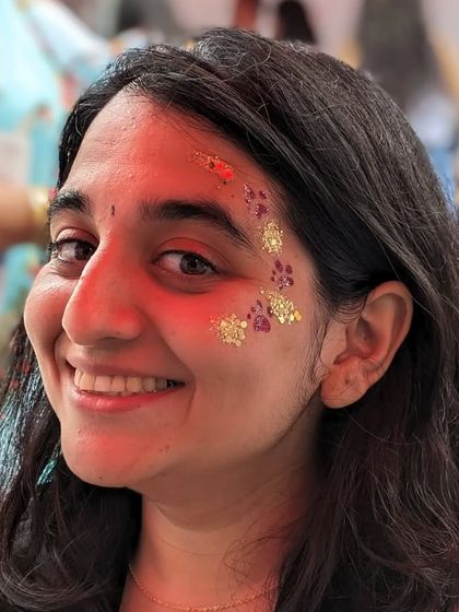 A fun and unique design featuring golden paw prints trailing up the side of the face.