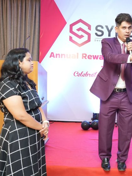 Interacting with a participant on stage during the Synergix Annual Rewards and Recognition night. I make sure everyone feels comfortable and celebrated.