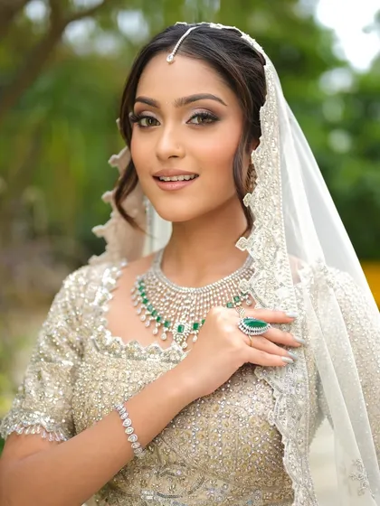 This bride looks absolutely radiant. Her soft glam makeup is paired with an elegant updo, creating a look that is both timeless and perfect for her wedding day.