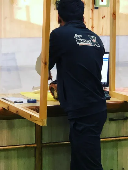 A behind-the-scenes look at a champion in the making. Manoj Sharma prepares for his shot during the Delhi State Shooting Championship, where his focus and training paid off.