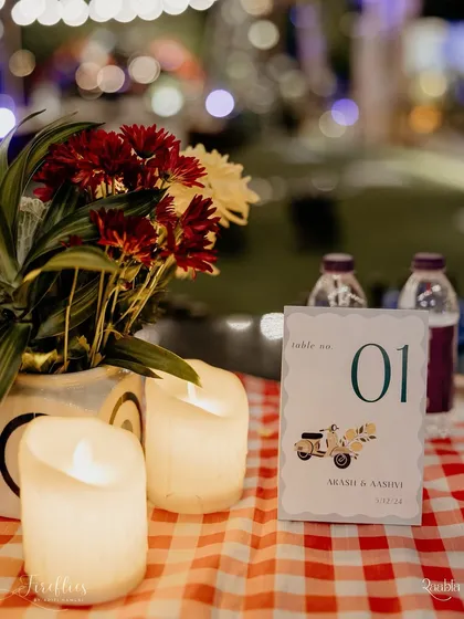A table number card with a scooter motif, continuing the fun, retro-Italian theme throughout the dinner setup.