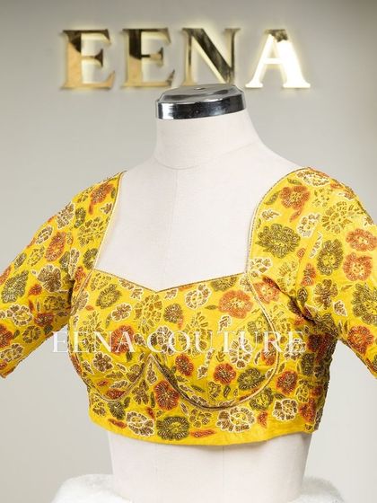Another take on the yellow raw silk blouse, this piece features a classic Katori cut. The front is kept simple to highlight the fit, while the back and sleeves are adorned with a vibrant floral pattern in multi-colored beadwork.
