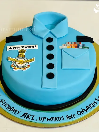 A retirement cake designed as an Air Force officer's uniform. This fondant cake is detailed with the official insignia, medals, and name tag for a truly personal tribute.