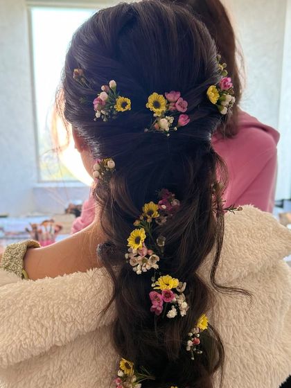 A behind-the-scenes shot of the floral braid being created.