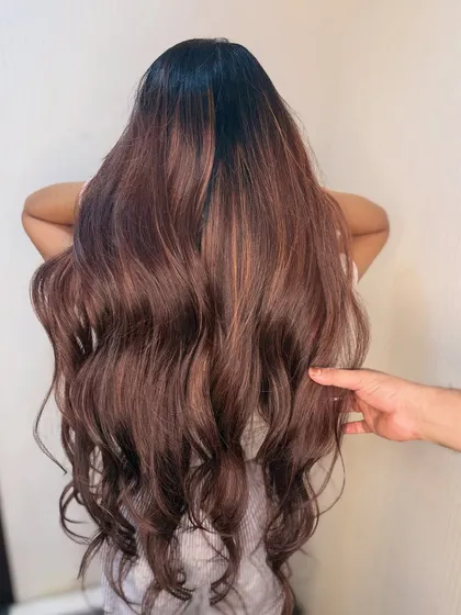 Our stylist demonstrating the softness and flow of the hair after a balayage service. Healthy, colored hair is our goal.