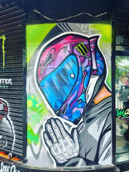 The other side of our mural for the Performance Racing store, featuring a stylized helmet and prayer hands. This piece blends modern aesthetics with a sense of respect for the ride.