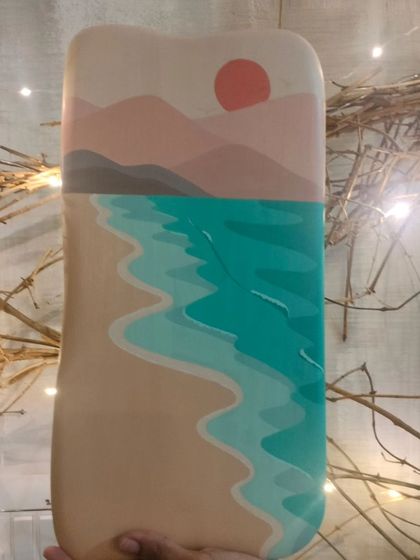 A hand-painted wooden art panel with a minimalist beach scene. The soft, abstract layers of sand, sea, and mountains create a calming and serene piece of decor.