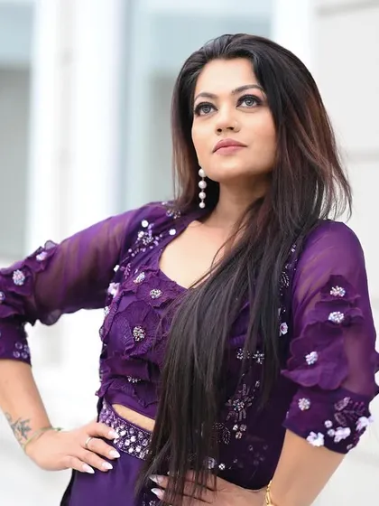 A powerful outdoor portrait of a model in a purple co-ord set, looking confident and stylish.