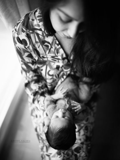 Happy Mother's Day. This artistic black and white shot of a mother looking down at her baby is a timeless tribute to the unbreakable bond they share.