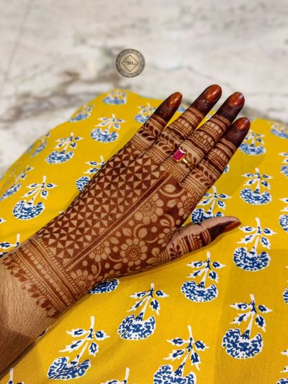A beautiful, even stain on a design filled with intricate gridwork. The color is rich and consistent across the entire hand.