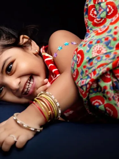 A cheerful and fun Diwali portrait. Dressed in her festive Indian attire, this little girl's bright smile perfectly captures the spirit of the festival of lights.