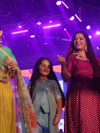 A candid moment with Jaya Kishori and a young fan on stage, highlighting the inclusive and family-friendly atmosphere I help create.
