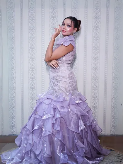 A full-length shot that captures the modern elegance of this fish-cut gown.