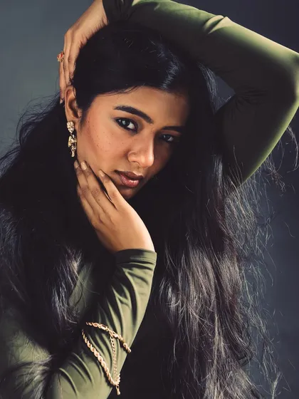 A classic portrait pose that feels intimate and engaging. The lighting is soft and flattering, focusing on the model's natural beauty.